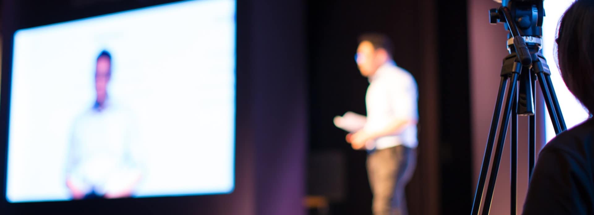 person on stage at a conference